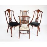 A pair of inlaid Edwardian mahogany side chairs, each with an open work splat above a padded seat