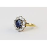 An Edwardian sapphire and diamond cluster ring, comprising, a central mixed cut oval sapphire