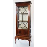 An Edwardian inlaid mahogany display cabinet, with a simulated inlaid dentil cornice above a