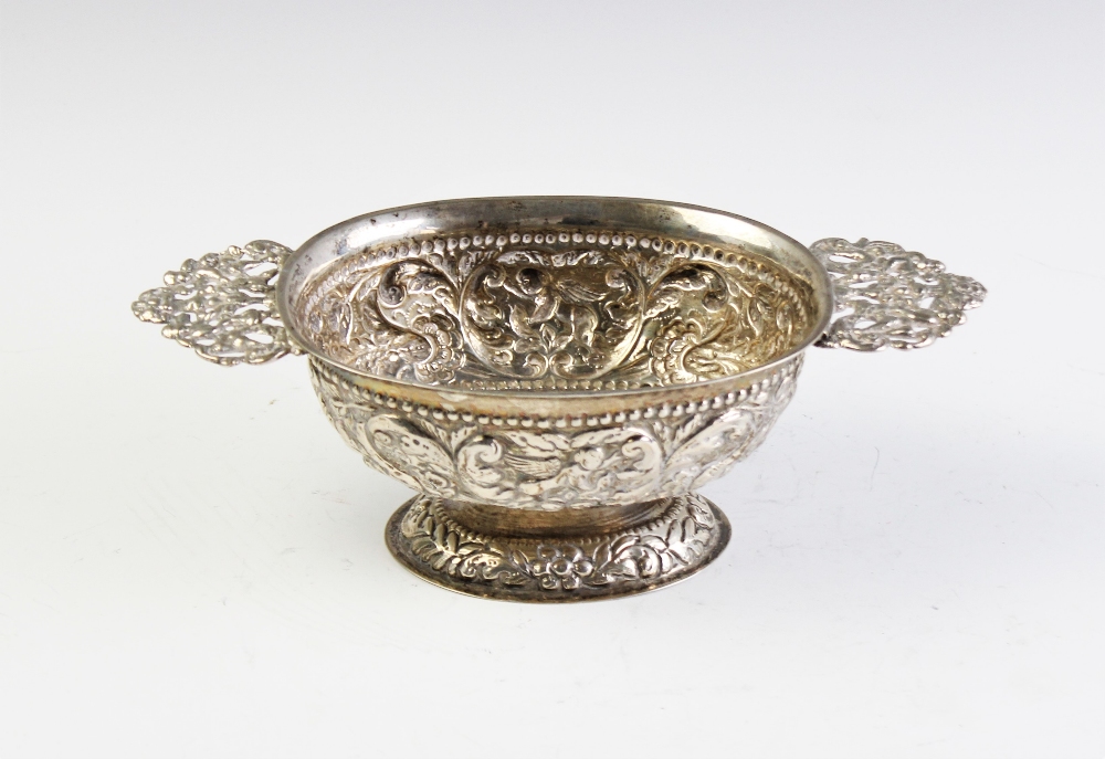 A Dutch silver brandy bowl, of oval form with cast pierced handles on domed foot, elaborately