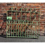 An early 19th century wrought iron garden gate, with scroll terminals on full length bars,