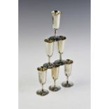 A set of six silver tots, each of tapering cylindrical form on circular spreading foot, 8cm high,