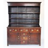 A late 18th century oak Welsh dresser, the high back with a moulded cornice above a plain frieze and