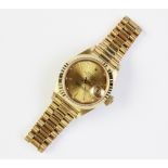 A lady's 18ct gold Rolex Oyster Perpetual Datejust wristwatch, the round gold toned dial with