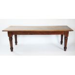 A 17th century style oak plank top table, 20th century, the cleated plank top raised upon ring
