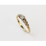 A diamond set 9ct gold ring, comprising a central round brilliant cut diamond weighing approx. 0.