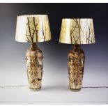 A pair of Japanese Satsuma lamp bases, 20th century, extensivley decorated and gilt highlighted with