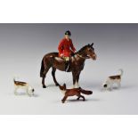A Beswick huntsman on horseback, two hounds and a standing fox, the huntsman on a bay horse, model