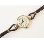 A lady's vintage Tudor 9ct gold wristwatch, the round white enamel dial with Arabic numerals, set to