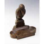 An early 20th century German carved wood poche vide, designed as a bird perched above a quatrefoil