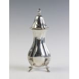 A silver sugar caster by Hampton Utilities, Birmingham 1976, of baluster form on four shell-capped