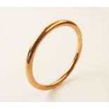 A 9ct rose gold slave bangle, plain polished exterior, 7.5cm diameter, weight 12.5gms