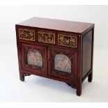 A Chinese stained hardwood side cabinet, early 20th century, with three frieze drawers carved with