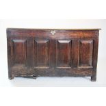 An 18th century oak coffer, the rectangular moulded twin plank top, above four invert moulded