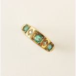 An emerald and diamond 9ct gold ring, comprising three round mixed cut emeralds, interspersed with