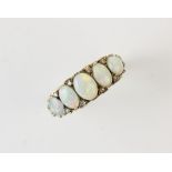 An opal five stone ring, comprising five graduated oval opal cabochons measuring between 5mm x 4mm