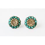 A pair of turquoise set floral cluster earrings, each designed as a yellow metal daisy with a border