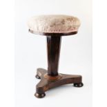 A mid 19th century rosewood adjustable pedestal piano stool, the revolving upholstered seat raised