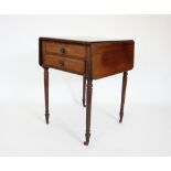 A Regency mahogany work table, the rectangular drop leaf top with a reeded edge, above a pair of