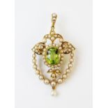 An Edwardian style peridot and seed pearl pendant/brooch, the central oval mixed cut peridot