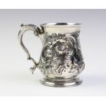 A George III silver tankard, London 1819, of baluster form with embossed floral decoration and