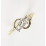 A diamond three-stone ring, comprising a central square cut diamond measuring approx. 0.15 carats,