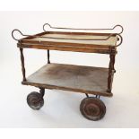 A 19th century two tier serving trolley, the upper tray with iron side rails upon turned supports
