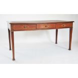 An Edwardian mahogany writing desk, the rectangular moulded top inset with a Moroccan red leather