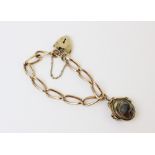 A 9ct gold charm bracelet, with a 9ct gold heart-shaped padlock fastener, 19cm long, suspending a