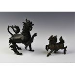 A Chinese bronze model of a Qilin, designed with raised right leg, removable cover, 26cm long, along