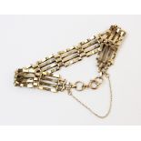 A 9ct gold gate link bracelet, 20cm long, 1.2cm wide, with spring ring and loop fastener and