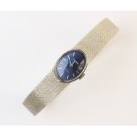 A lady's vintage 14ct white gold Tudor wristwatch, the blue oval shaped dial with baton markers, set