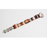 A Victorian Scottish hardstone 'buckle' bracelet, comprising carved carnelian panels with white