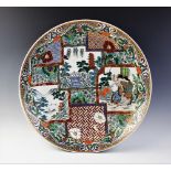 A large Japanese porcelain charger, 20th century, of circular form decorated with geometric panels