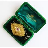 A Victorian ruby and pearl set memorial brooch, comprising a central oval mixed cut ruby measuring
