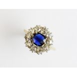A Victorian sapphire and diamond cluster ring, comprising a central cushion cut blue sapphire