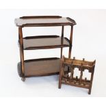 An Ercol elm three tier tea trolley, the three galleried tiers raised upon tapering supports and