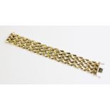 A 1970's 9ct gold brick link bracelet, comprising alternating brushed and polished brick-links, with
