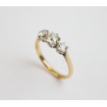 An early 20th century diamond three stone ring, comprising a central old cut diamond weighing