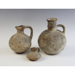 Three Ancient Cypriot pottery vessels, possibly Mycenaean Period, comprising; three handled ewers,