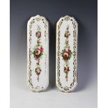 Two door finger plates in the manner of Coalport, each decorated with floral and foliate sprays