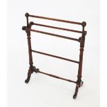 A Victorian mahogany Gothic influence towel rail, with spherical shaped finials upon fluted and