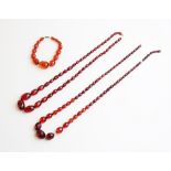 A cherry amber coloured beaded necklace, comprising forty-seven graduated faceted beads measuring