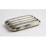 A George V silver cigar case by John Rose, Birmingham 1913, of typical form with scrolling foliate