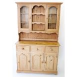 A Victorian style pine kitchen dresser, late 20th century, the high back with a pair of glazed doors