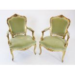 A pair of French Louis XV style gilt wood fauteuil, late 19th century, each with a carved