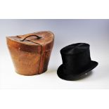 A Victorian Tress & Co silk top hat with leather hat box, makers name to the inside of the hat,