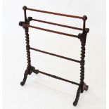 A Victorian mahogany towel rail, with spherical finials upon barley twist uprights and down swept