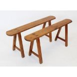 A pair of French cherry wood benches, late 19th/ early 20th century, the slender rectangular tops