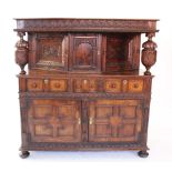 A 17th century style oak court cupboard, late 19th century, profusely carved with a lunette frieze